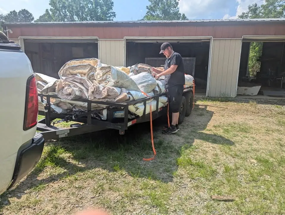 Crew loading renovation debris into a dump trailer
