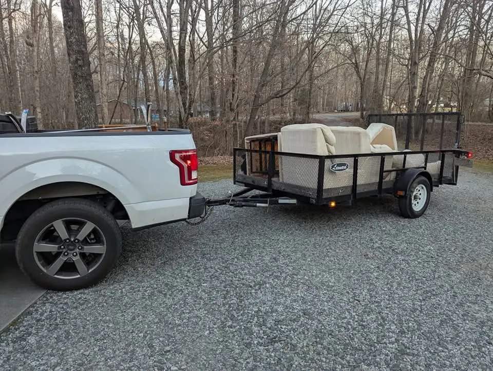 Utility trailer staged with furniture for junk removal